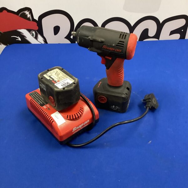 Snap On cordless drill set with charger and batteries.