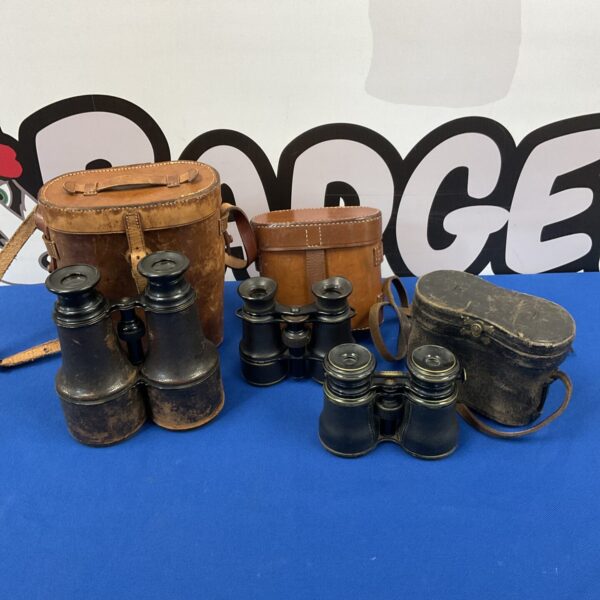 Vintage binoculars with leather cases, antique optics collection.