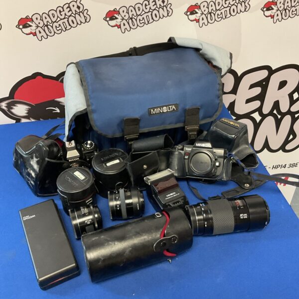 Vintage Minolta camera lot with lenses and accessories.