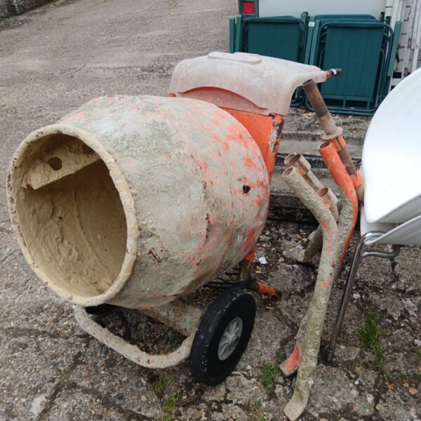 Portable Belle cement mixer showing signs of wear.