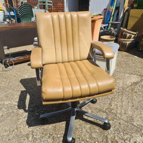 Vintage Verco swivel chair with tan leather seat and chrome base.
