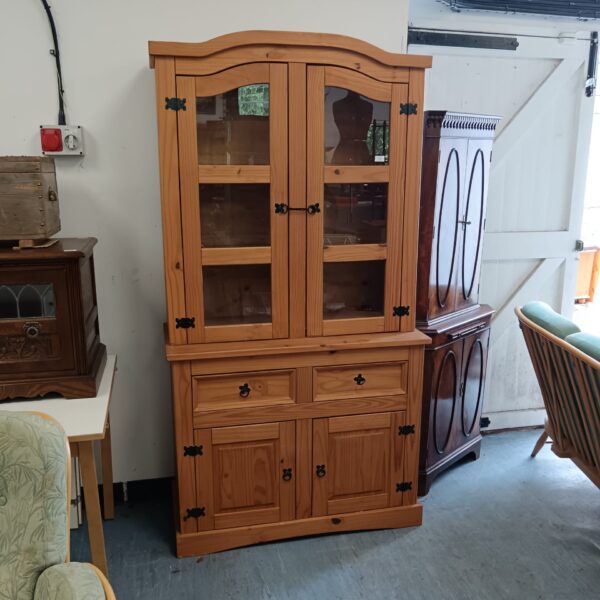 Vintage pine display cabinet with glass doors and iron accents.