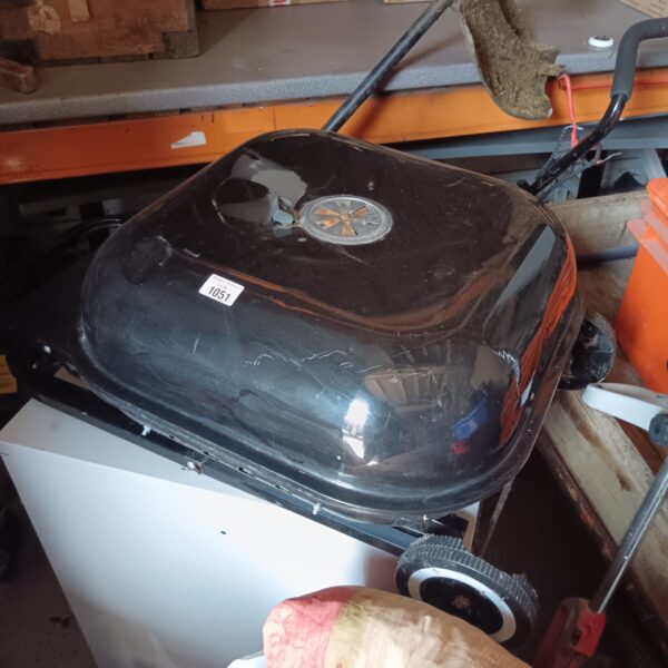 Used folding BBQ grill on wheels for outdoor cooking.