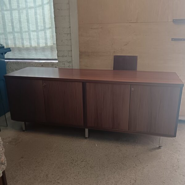 Front view of vintage walnut storage cabinets with keys.
