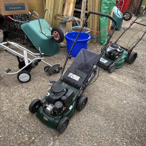 Used Webb WER400 petrol lawn mower in a garden setting.