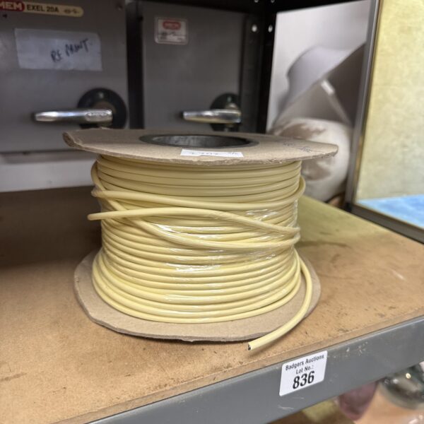 Vintage telephone cable reel, part-used, showing the remaining wire.