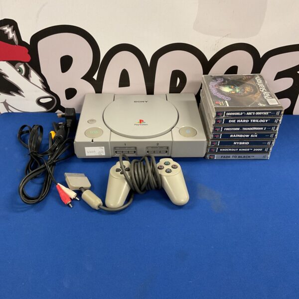 Vintage Sony PlayStation 1 console with controller and cables.