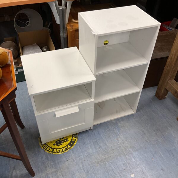 White bedside table with shelving unit for bedroom storage.