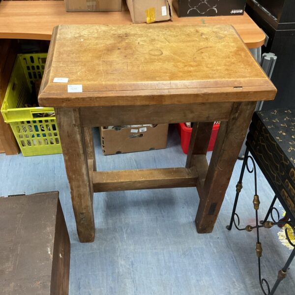 Antique French butcher block table with a worn surface.