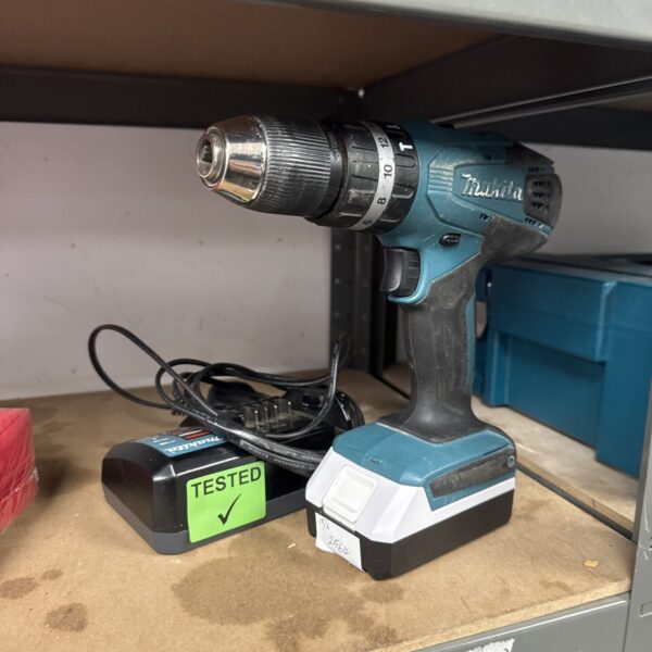 Makita HP457D cordless drill with charger, close-up view.