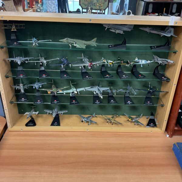 Display case filled with a variety of model planes and aircraft.