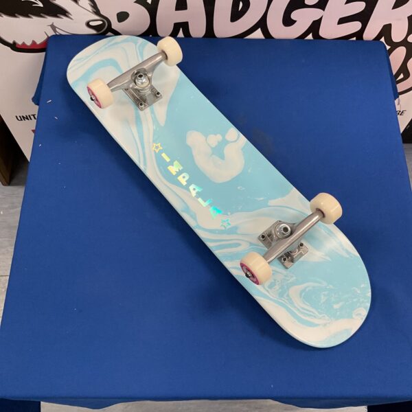 Blue and white Impala Cosmos skateboard with Tensor trucks.