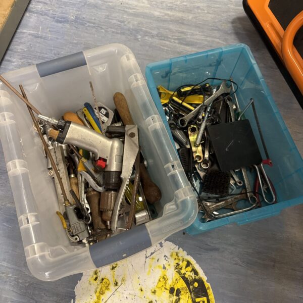 Assorted hand tools in a plastic tub, workshop collection.