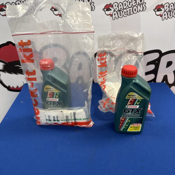 Two sealed Castrol GTX Magnatec 10W40 oil kits for car maintenance.