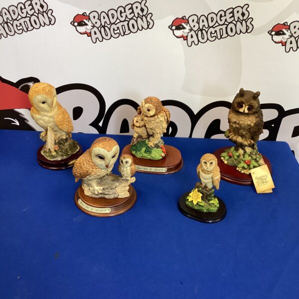 Detailed ceramic owl figurines displayed as a collectible set.