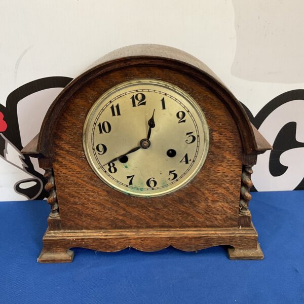 Antique oak mantle clock needing restoration, front view.