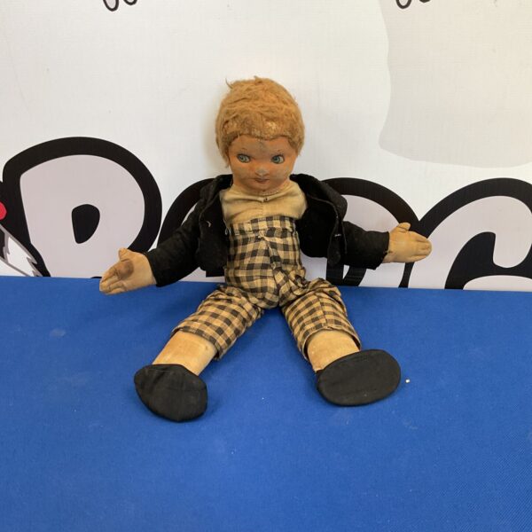 Antique cloth doll with printed face and vintage clothing.