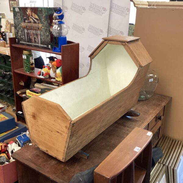 Antique Victorian pine rocking crib, a charming nursery collectible.