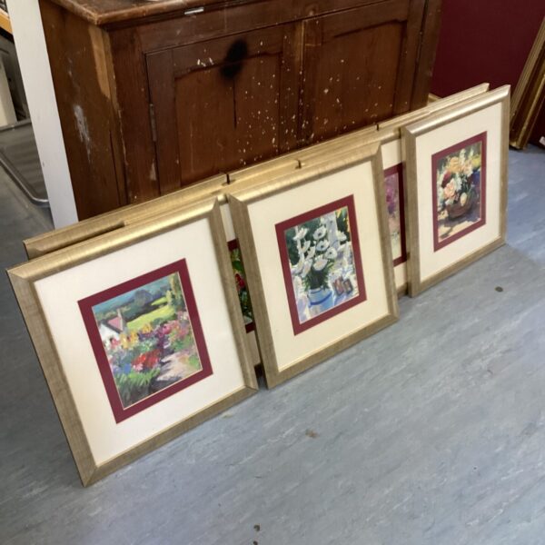Group of nine framed flower prints for vintage wall decor.