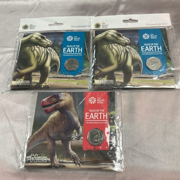 Royal Mint Tales of the Earth Dinosauria coins, detailed dinosaur designs.