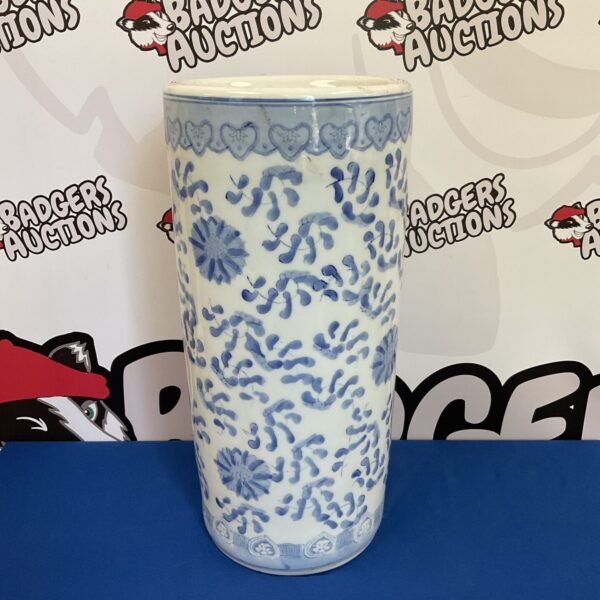 Vintage blue and white ceramic umbrella stand with floral design.