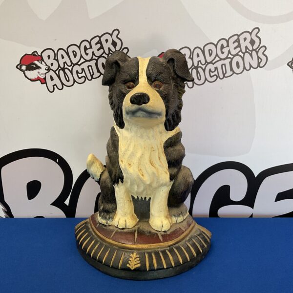 Antique cast iron collie dog doorstop with detailed sculpting.