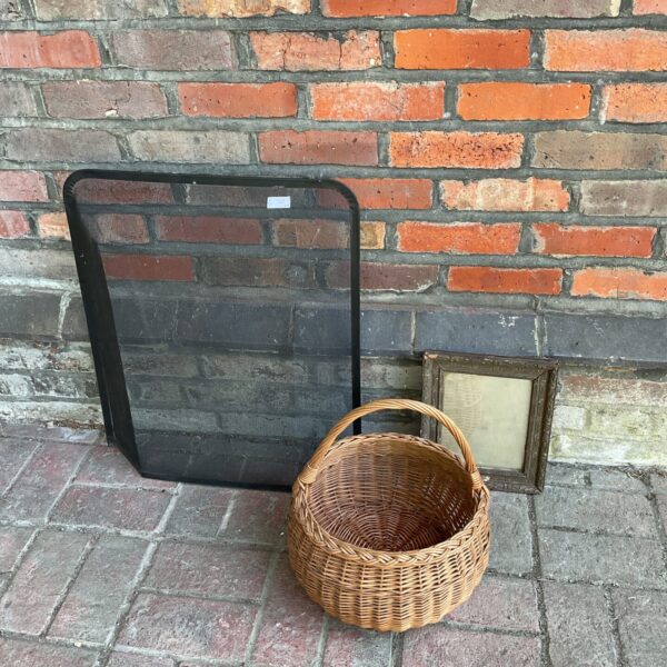Vintage wicker basket with photo frame and mesh firescreen.