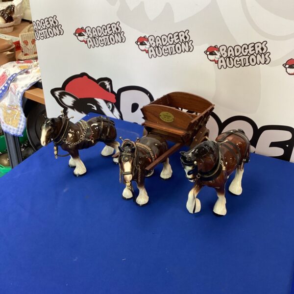 Detailed porcelain Shire horse figurines with a miniature cart.