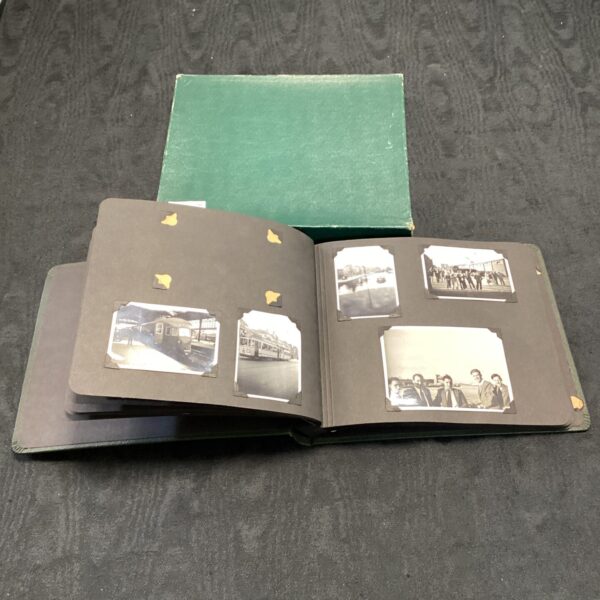 Vintage 1920s travel photo album cover with aged appearance.
