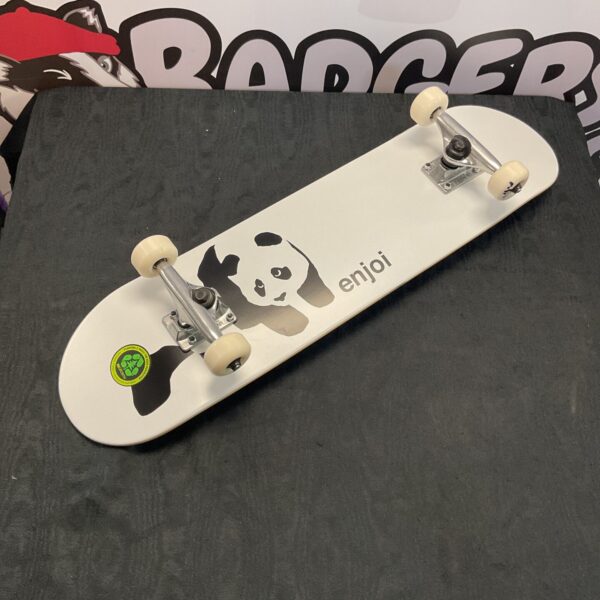 White enjoi skateboard with a panda graphic and tensor trucks.