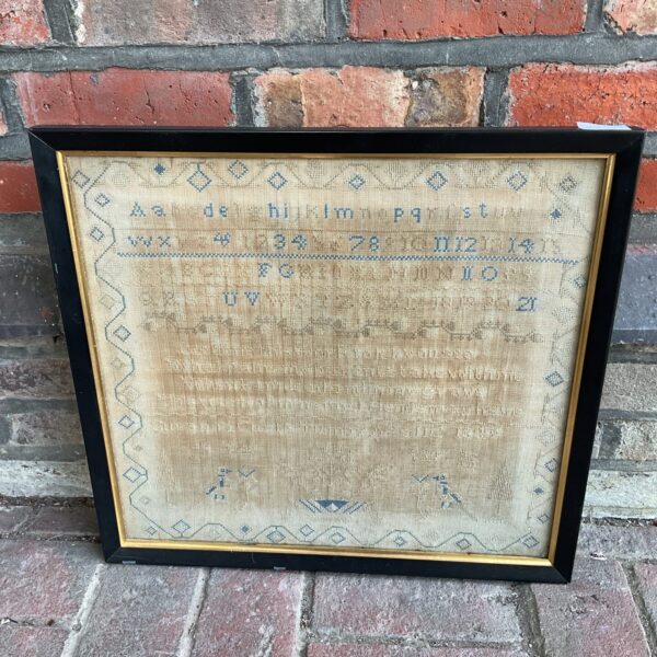 Antique embroidered sampler from 1849, showcasing Victorian needlework and folk art.