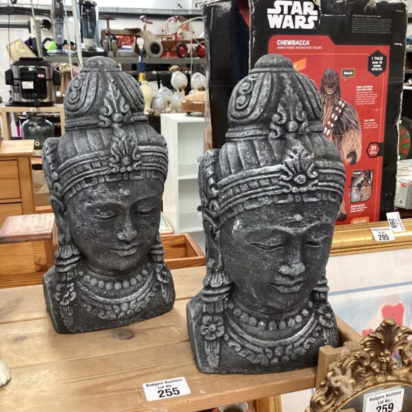 Pair of carved stone Buddha heads for home decor.