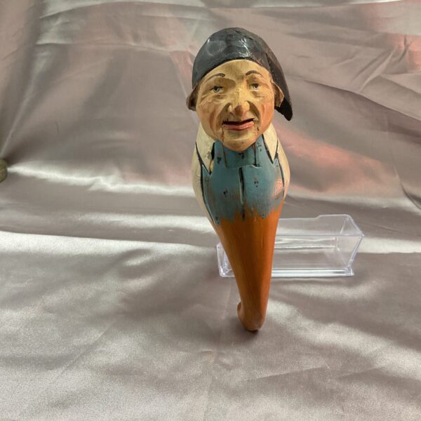 Front view of a vintage French hand-carved wooden puppet.