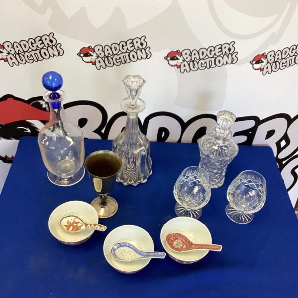Vintage crystal brandy glasses and decanter set on display.