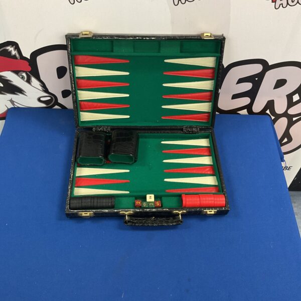 Vintage travel backgammon set with a folding board and pieces.