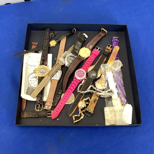 Tray of mixed vintage and fashion wristwatches for collectors.