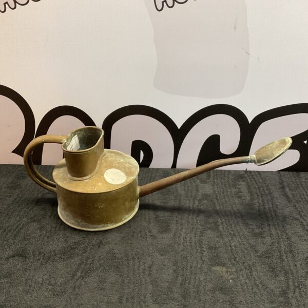 Vintage brass and copper watering can for garden use.