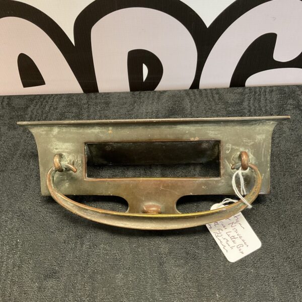 Antique art nouveau brass letter box with decorative front plate.