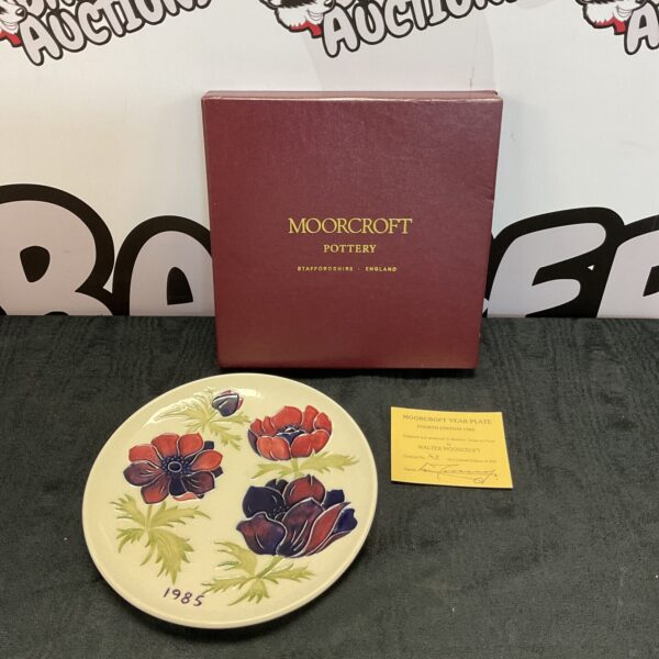 Moorcroft 1985 floral plate with certificate, collectible pottery.
