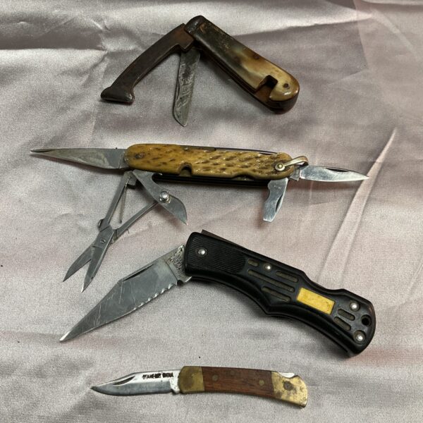 Lot of four vintage pocket knives with bone and wood handles.