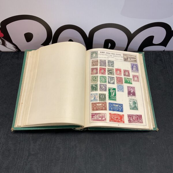 Open vintage stamp album displaying Irish stamps on the pages.