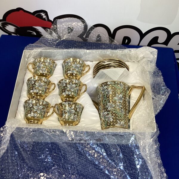 Vintage patterned coffee set with porcelain cups and saucers.