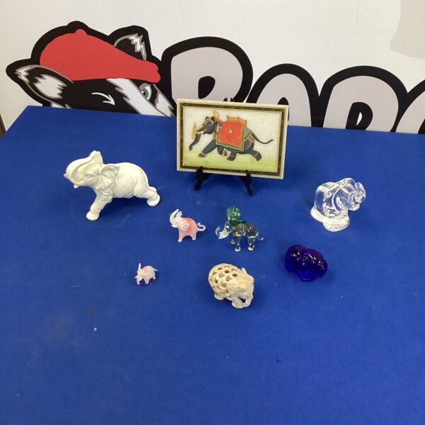 Selection of small elephant ornaments, collectible figurines on display.