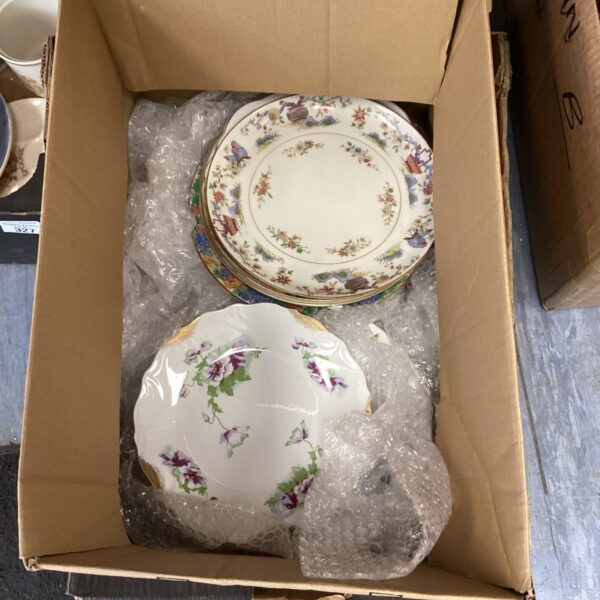 Vintage Royal Worcester plates with floral designs in a box.