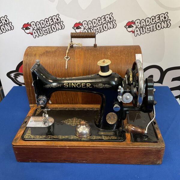 Vintage Singer EA575305 sewing machine with ornate gold detailing.