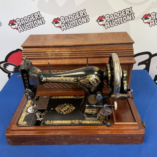 Vintage Singer J366734 sewing machine with ornate gold detailing.