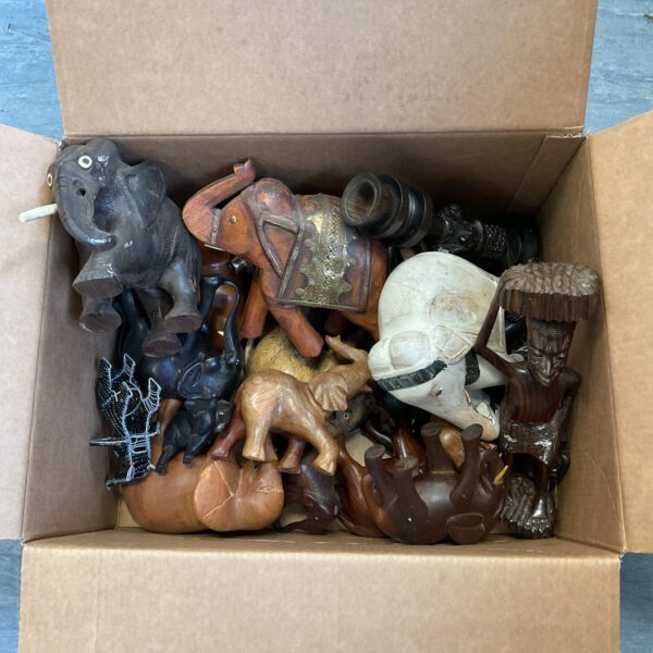 Diverse collection of carved wooden elephants on display.