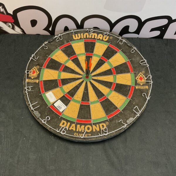 Used Winmau dartboard with visible wear and tear.