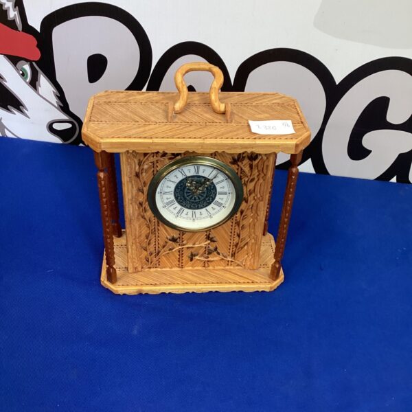 Vintage Mercedes carriage clock with detailed brass casing.