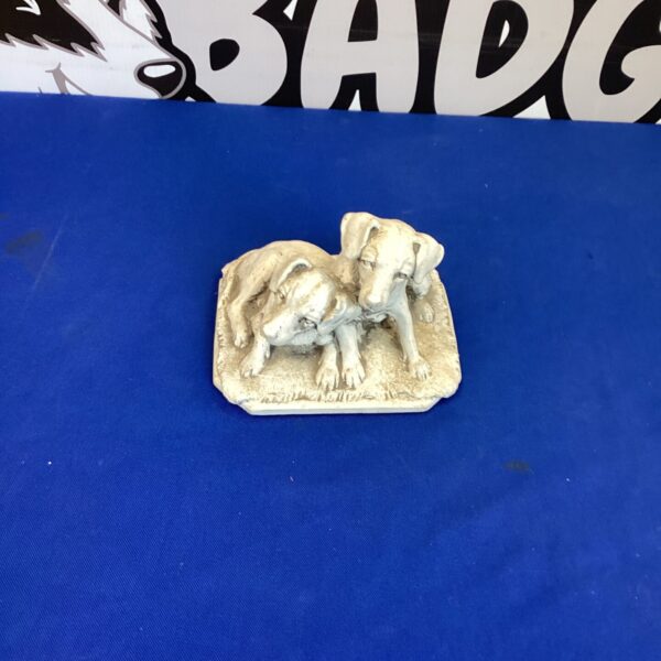 Vintage dog statue featuring a pair of dogs.